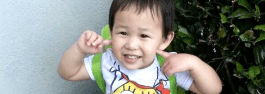 Picture of a little boy, preparing for a visit to Dr Pham and pointing to his teeth